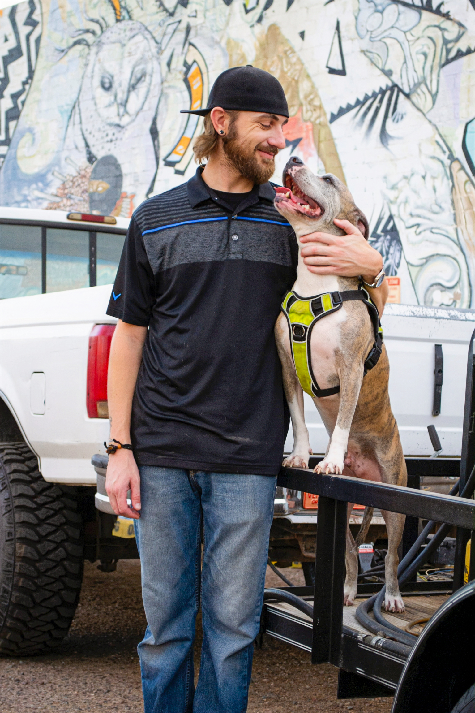 Scotty Norgren of Black Feather PHX Pressure Washing with his dog